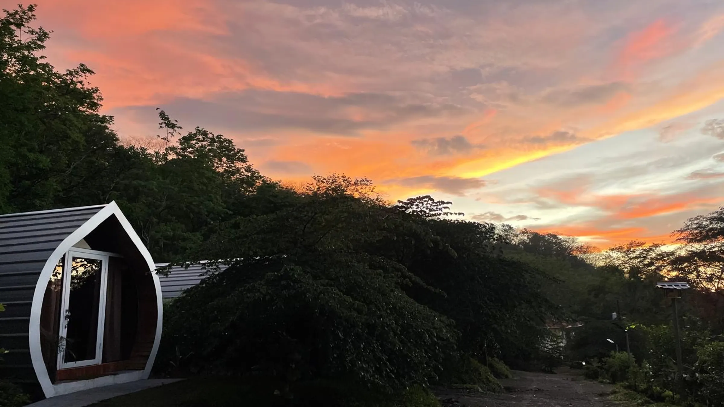 A capsule cabin at Villas Alice against a Guanacaste sunset